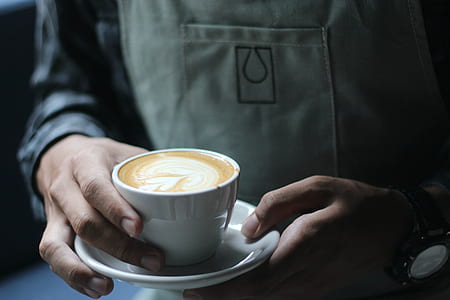 person holding cup of coffee thumbnail