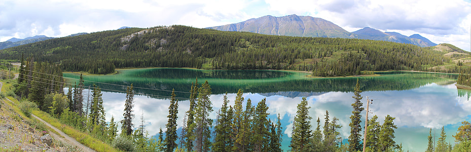 mountain near body of water surrounded with trees thumbnail