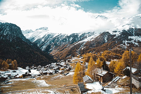 ice-covered mountain near house thumbnail