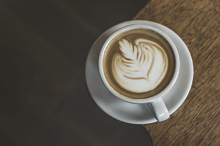 cup of heart latte on top of brown surface thumbnail