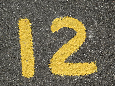 yellow 12 painted on concrete surface thumbnail