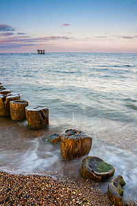 body of calm water under blue sky during daytime thumbnail