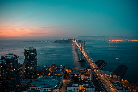 aerial photography of lightened bridge near body of water during golden hour thumbnail
