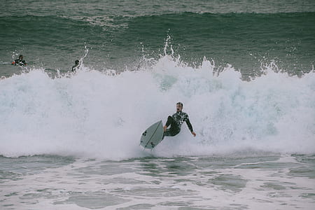 person surfboarding during daytime thumbnail