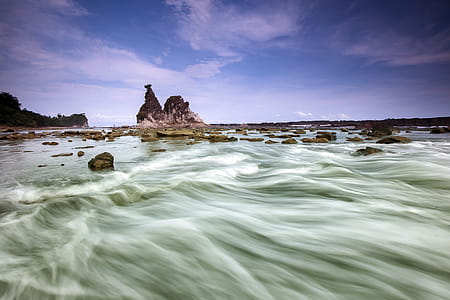 time lapse photography of sea and rocks thumbnail