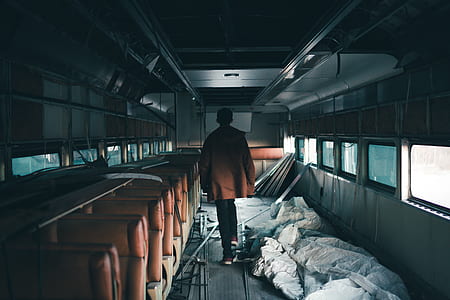 man standing inside train at daytime thumbnail