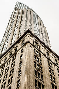 brown concrete high-rise building under cloudy skies thumbnail