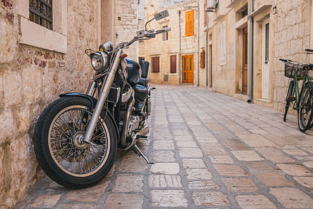 silver and black touring motorcycle on alley thumbnail