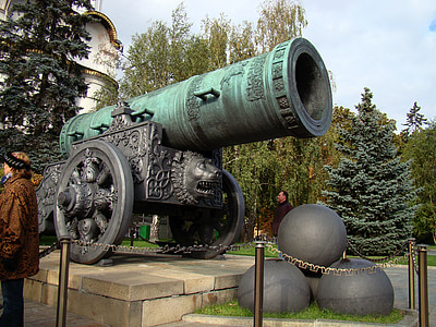 teal and gray metal cannon monument during daytime thumbnail
