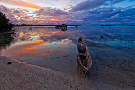 brown boat on calm sea thumbnail