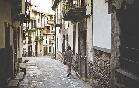 woman wearing gray dress walking on alley thumbnail