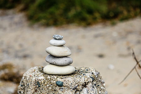 selective focus photography of stacked stones thumbnail