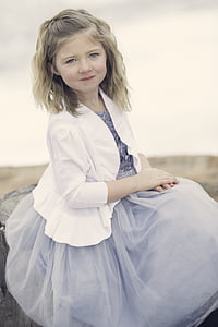 girl in gray dress and white bolero sitting with her hands on her lap thumbnail