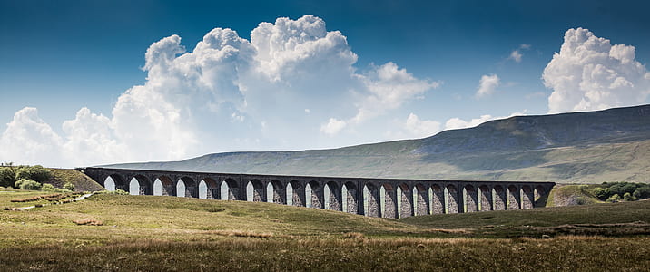gray concrete bridge under blue and white sky at daytime thumbnail