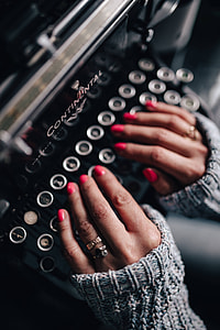 Woman typing on an old typewriter thumbnail