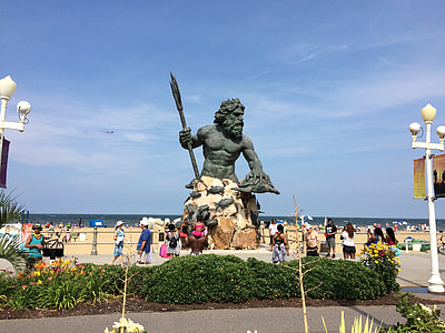 Poseidon statue near body of water thumbnail