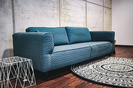 Blue sofa with pillows in a designer living room interior thumbnail