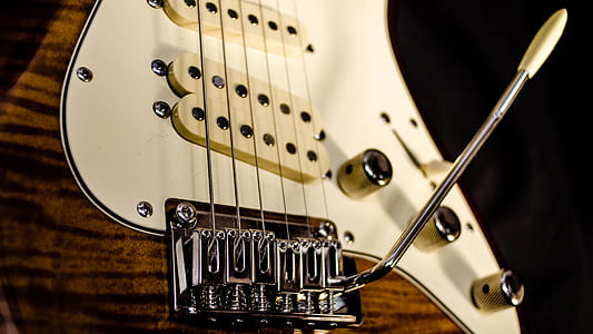 brown and white electric guitar with tremolo thumbnail
