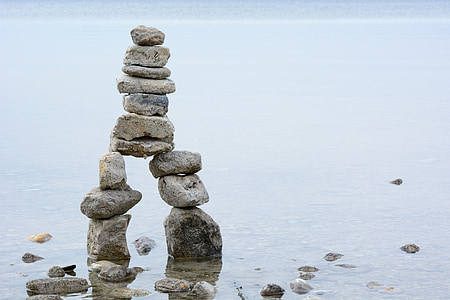 stone balancing on body of wter thumbnail