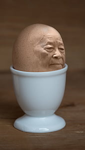 egg with face in white cup thumbnail