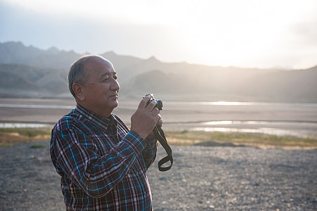 man holding MILC-camera thumbnail