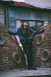 woman standing in between brown brick domes thumbnail