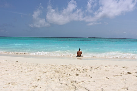 man sitting on shoreline thumbnail
