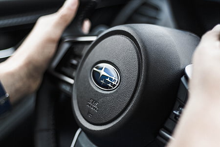 black Subaru steering wheel in close-up photo thumbnail