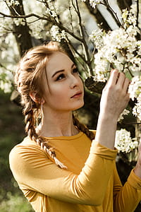 woman holding flowering tree thumbnail