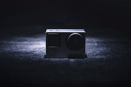 gray GoPro Hero 4 on black surface thumbnail