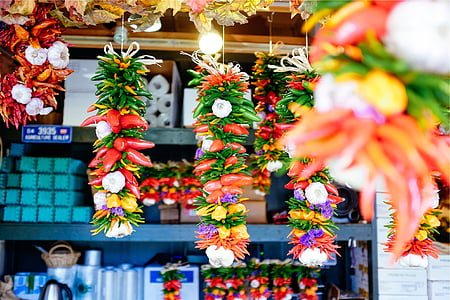 close-up photo of multicolored vegetables hanging near blue shelf rack thumbnail