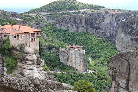 orange and beige concrete building on top of rock mountain during daytime thumbnail