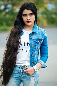 woman in blue denim jacket and jeans facing camera thumbnail