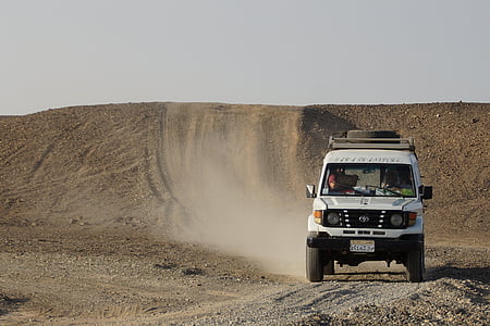 white SUV on dirt road at daytime thumbnail