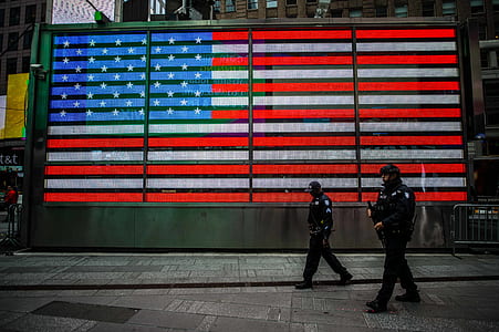 two policemen walking on concrete blocks thumbnail