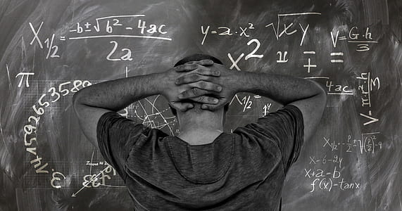 man wearing gray shirt facing on blackboard thumbnail