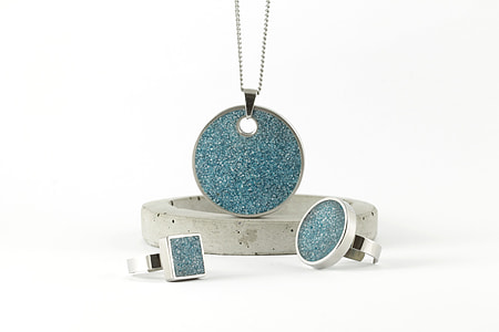 silver-colored blue gemstone pendant necklace, bracelet, and two rings placed on white surface thumbnail