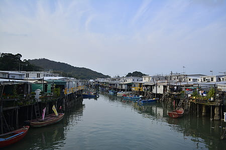 canal between houses under calm sky thumbnail