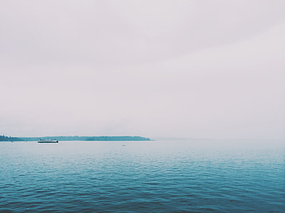 ferry maneuvering on body of water during daytime thumbnail