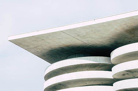 photo of high-rise white concrete building during daytime thumbnail