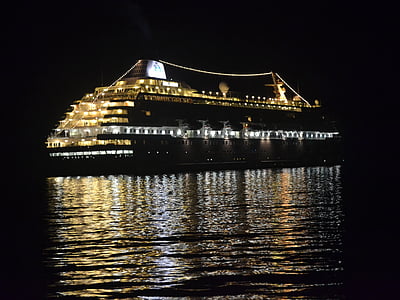 cruise ship sailing on body of water during nighttime thumbnail