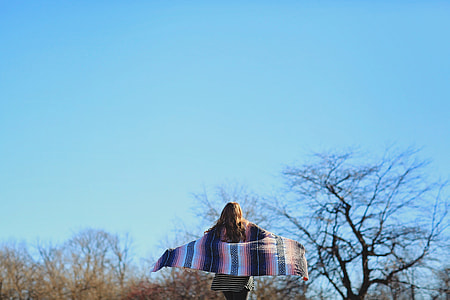 woman holding black and white scarf thumbnail