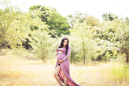 Woman Standing On Grass Field Surrounded With Trees thumbnail