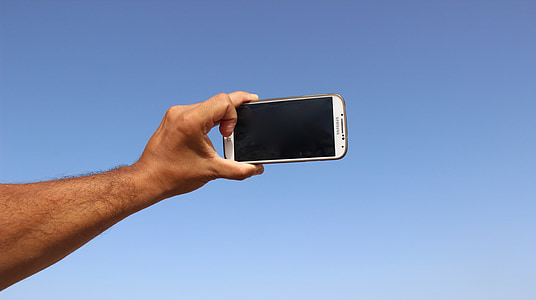 person holding Samsung Android smartphone thumbnail