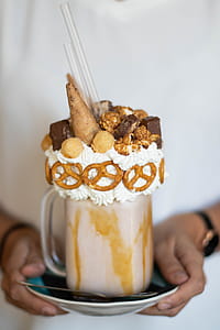 Person Holding Saucer With Mug of Chocolate Ice Cream Coffee thumbnail