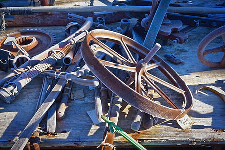 brown metal wheel placed on wooden table thumbnail