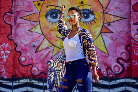 woman wearing purple and multicolored jacket in front of sun wall art thumbnail