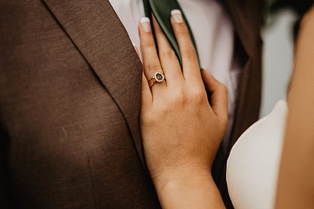 woman wearing white dress with hand on man's chest thumbnail