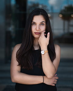 woman wearing watch touching her own cheek with left hand thumbnail