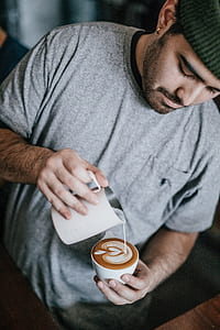 man wearing grey shirt pouring coffee in mug thumbnail